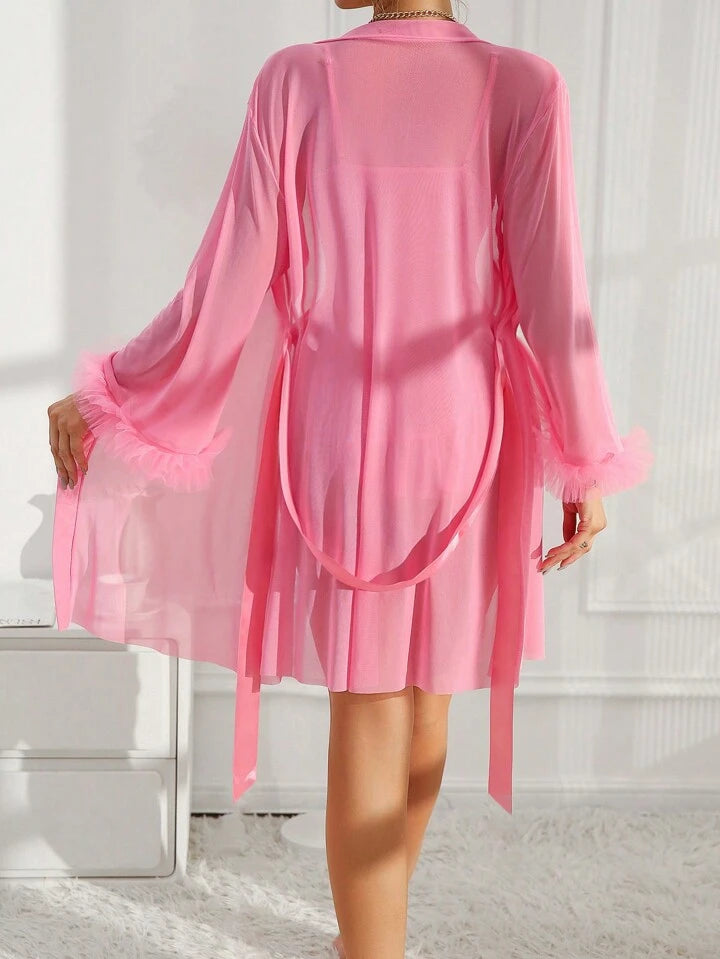 Pink sheer robe worn by a person on a white background
