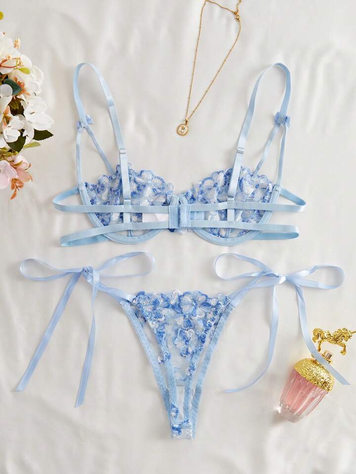 Blue floral lingerie set with ribbons on a light background