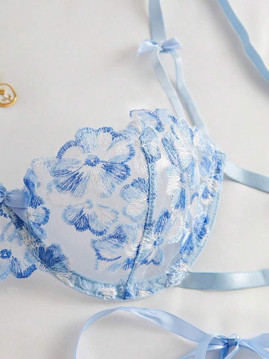 Blue floral lace bralette with matching panties on a light background