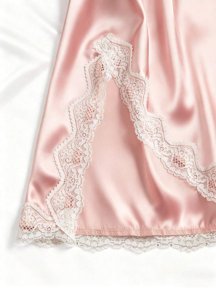 Pink satin fabric with lace trim on a white background