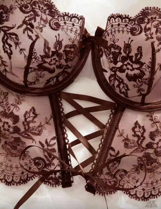 Brown lace underwire bra with floral lace cups and a matching lace corset-style garter belt with crisscross front straps, shown on a light background.