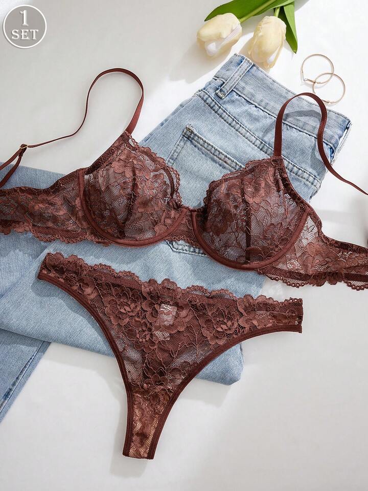 Brown lace lingerie set with denim shorts and white tulips on a light background
