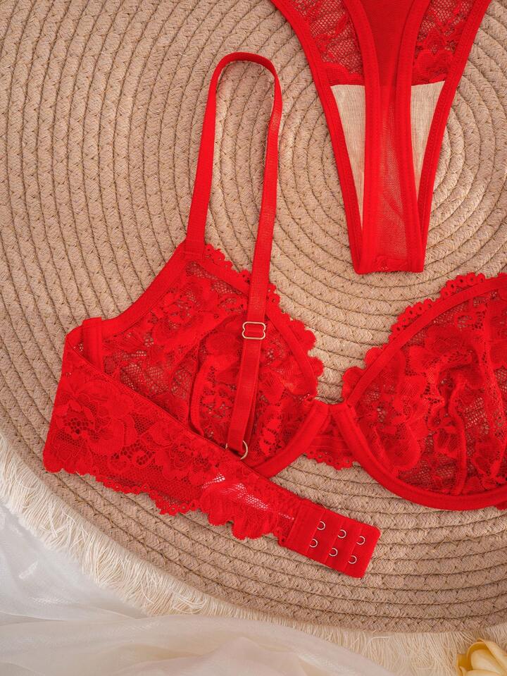 Red lace lingerie set on a textured surface