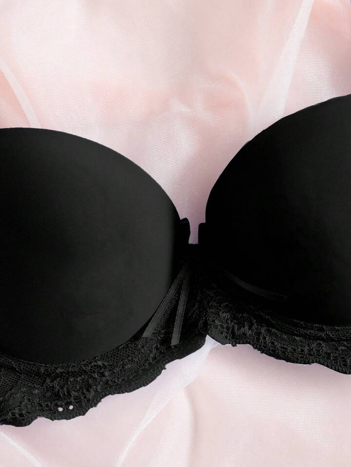 Black bra on a light pink background