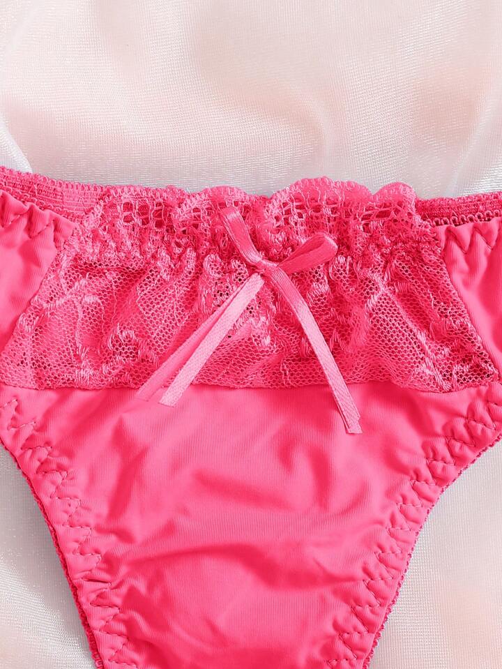 Close-up of pink lace-trimmed underwear on a light background