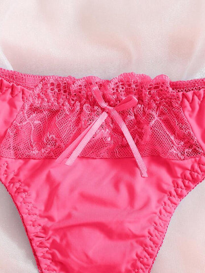 Close-up of pink lace-trimmed underwear on a light background