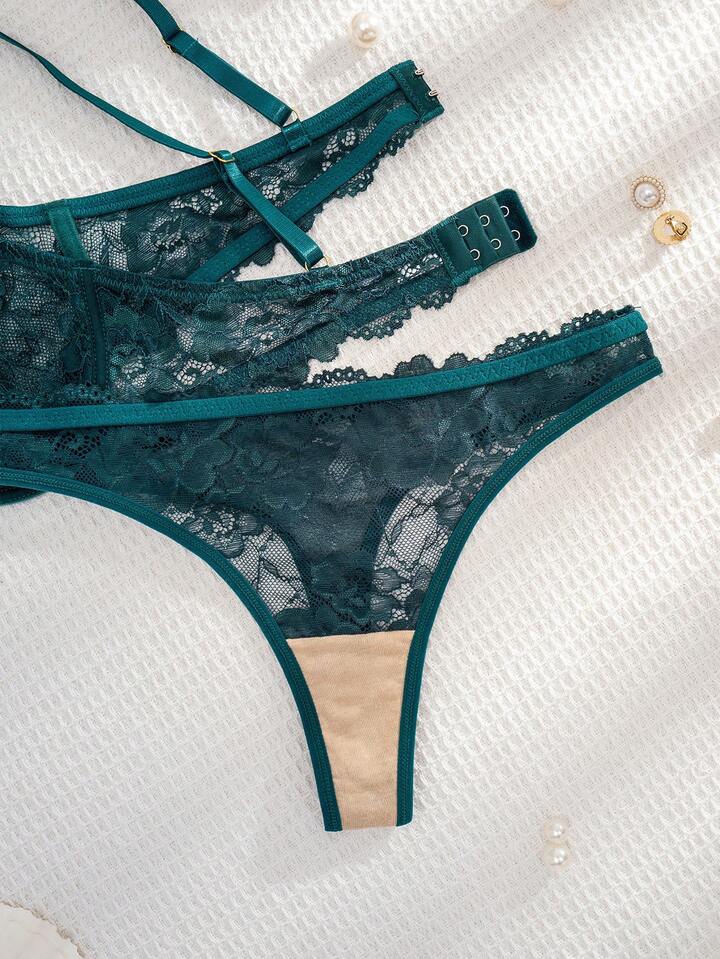 Green lace lingerie set on a textured white surface