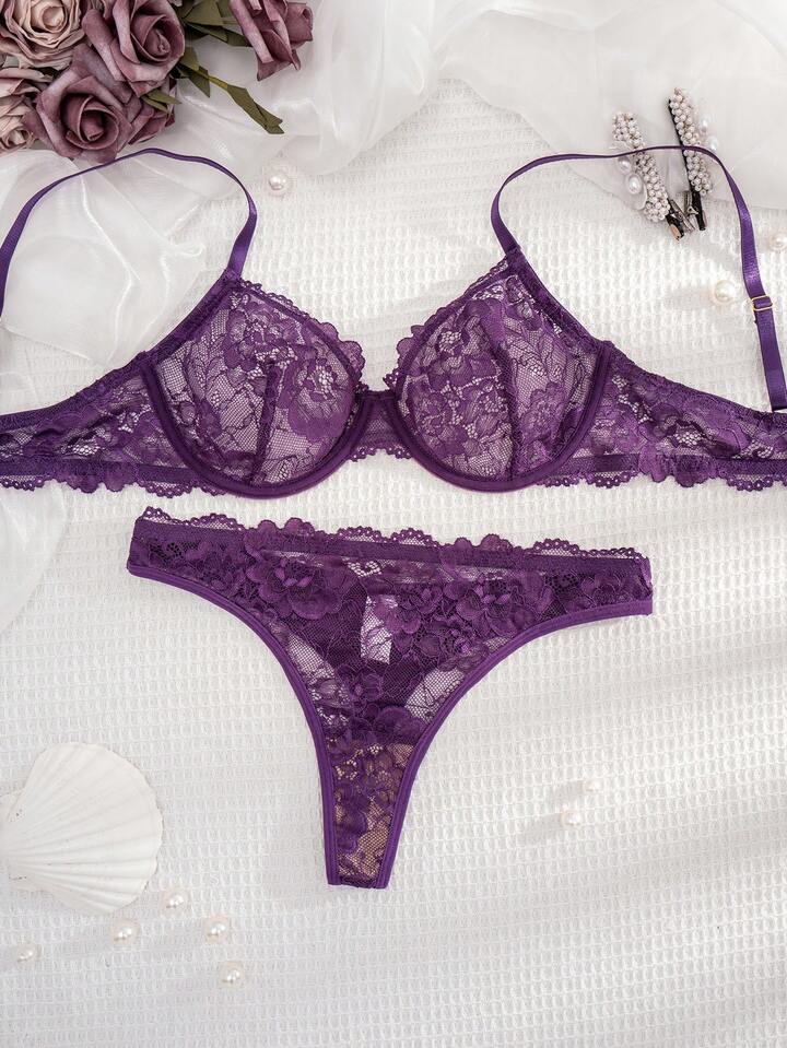 Purple lace lingerie set on a white background with flowers and pearls.