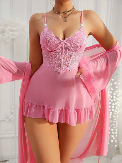 Pink lace lingerie set with matching robe against a white background