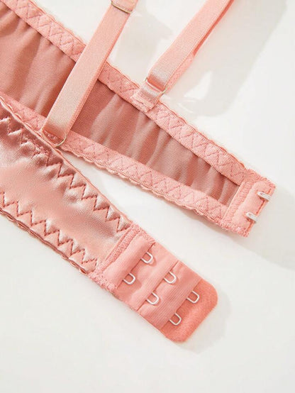 Close-up of pink lingerie with lace details on a white background