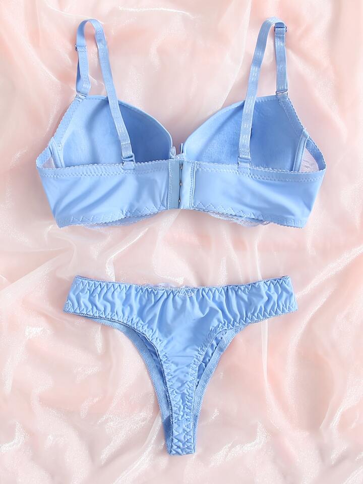 Light blue bra and panties set on a pink background