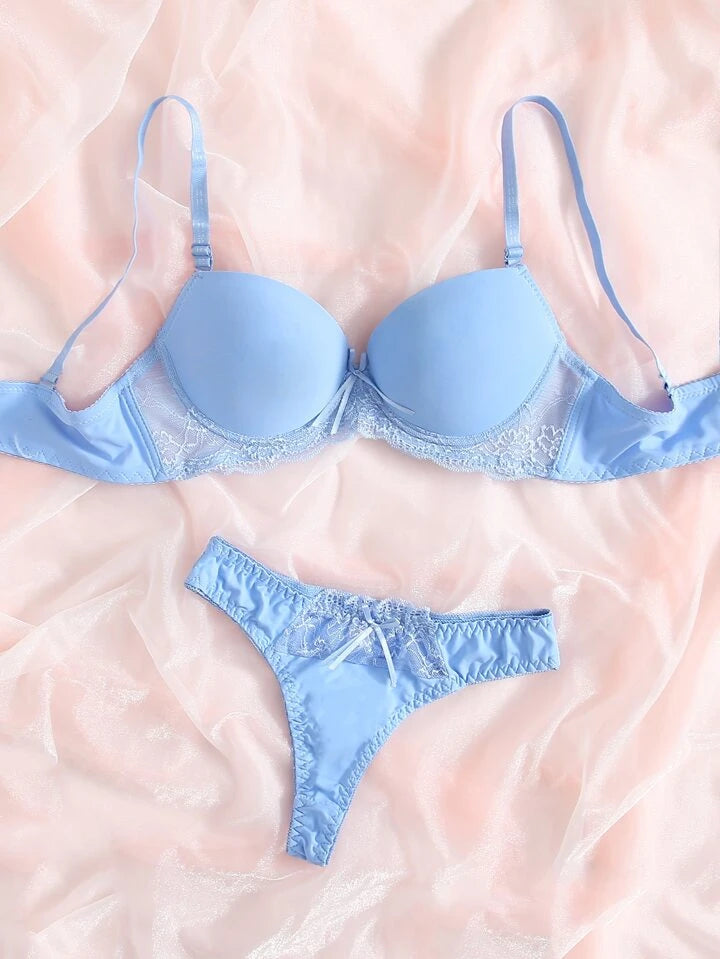 Light blue bra and panties set on a soft pink background