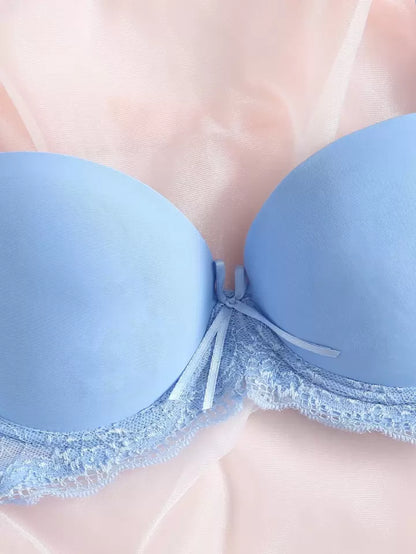 Light blue bra with lace trim on a neutral background