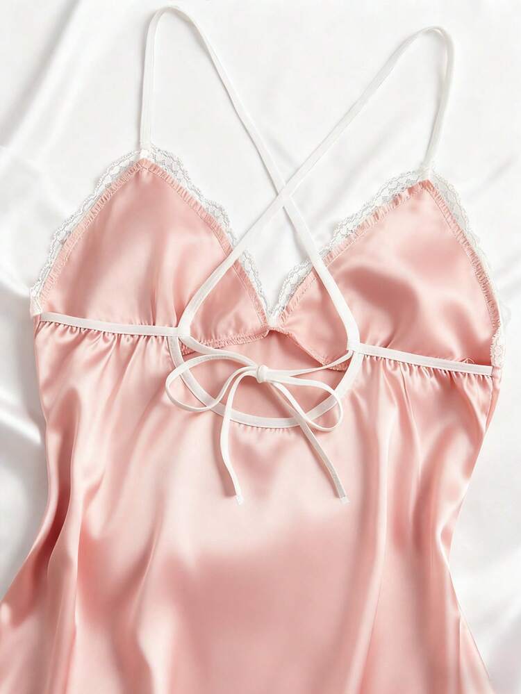 Pink satin nightgown with lace trim on a white background