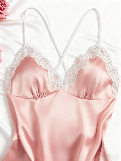 Pink satin nightgown with lace details on a white background