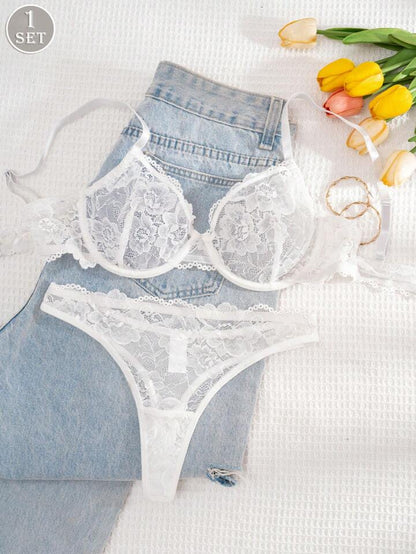 White lace lingerie set with denim shorts on a white background with tulips.