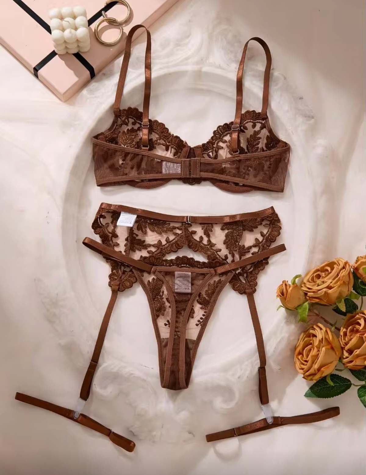 A three-piece brown lace lingerie set with garter